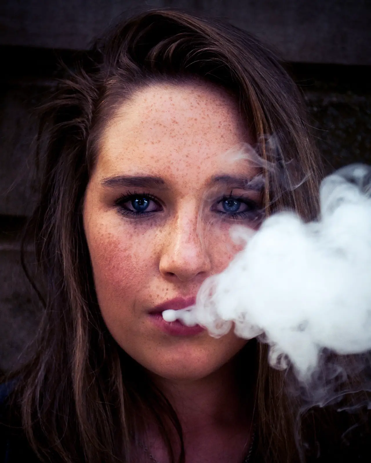 a woman vaping, not knowing that electronic cigarettes are still as harmful as tobacco cigarettes.